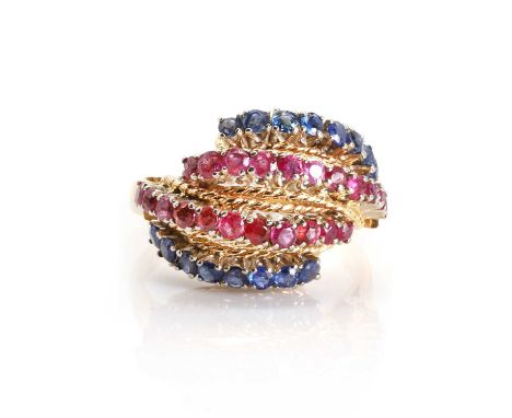 A four row sapphire and ruby bombe ring, c.1950,  with four rows of circular mixed cut gemstones, all four claw set in arched