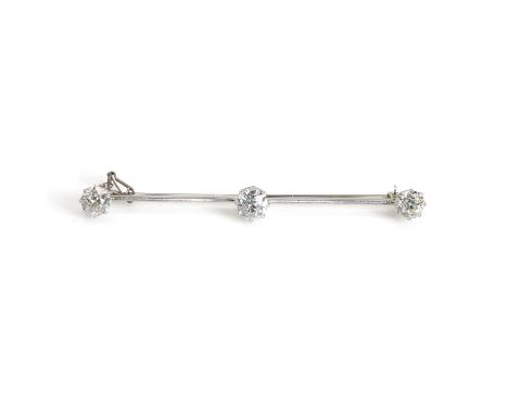 A platinum and diamond bar brooch, three graduated old mine cut diamonds claw set to rex collets, mounted on a plain blade ed