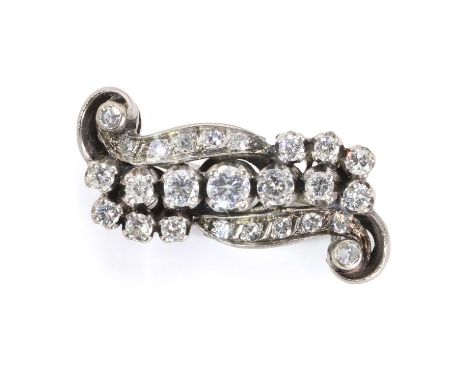 A diamond set scroll brooch, comprising a central line of graduated round brilliant cut diamonds, within two scrolling panels