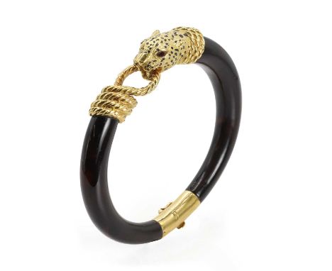An 18ct gold and tortoise shell bangle, by Gay Frères, c.1970, a carved tortoiseshell tapered bangle to an 18ct gold panther 