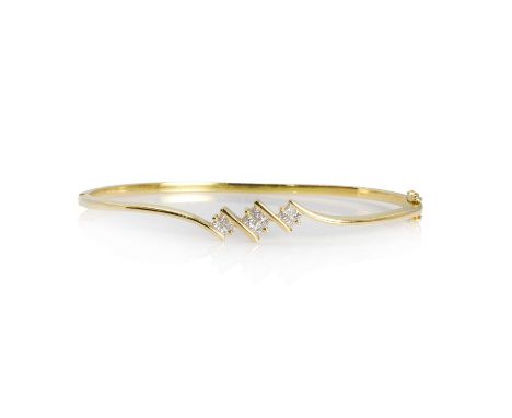 A diamond hinged bangle, with three inset panels of graduated princess cut diamonds, mounted to the crossover design top half