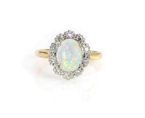 An 18ct gold opal and diamond cluster ring,  with a central oval cabochon opal, claw set, surrounded by illusion set diamonds