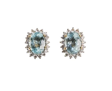 A pair of 18ct gold tourmaline and diamond cluster earrings, each with an oval mixed aqua blue tourmaline, 7 x 5mm, claw set 