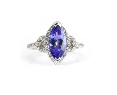 A white gold tanzanite and diamond ring,  set with a navette cut tanzanite, with a stated weight of 2.22ct, within a halo of 