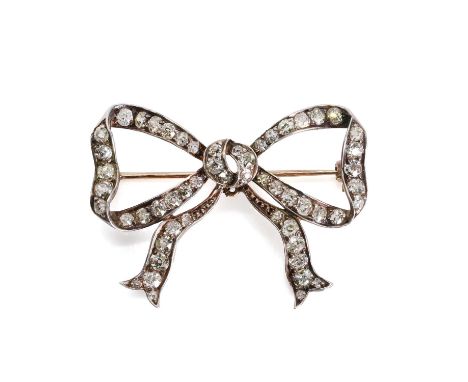A Victorian diamond set bow brooch,  with lines of graduated old Swiss cut diamonds, all grain set to the ribbon. Central pen