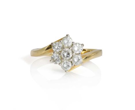 An 18ct gold diamond floral cluster ring,  with seven round brilliant cut diamonds claw set in a white wire basket, to crosso
