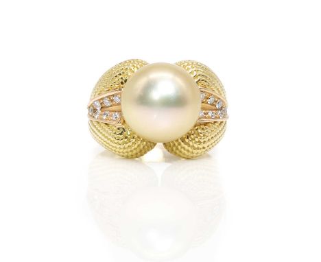 A pearl and diamond ring,  with a slightly button-shaped golden cultured pearl, untested, 11.60mm in diameter, peg set to the