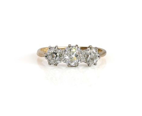 An early 20th century diamond three stone ring,  with three graduated old mine cut diamonds, the principal one measuring appr