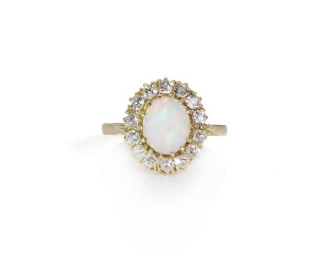 An opal and diamond cluster ring,  the coronet cluster centrally set with an oval cabochon opal within a border of Swiss cut 