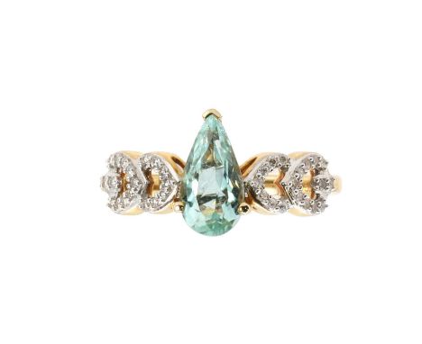 An 18ct gold tourmaline and diamond ring,  centrally set with an aqua colour pear cut tourmaline, 5.50 x 10.50mm, flanked by 