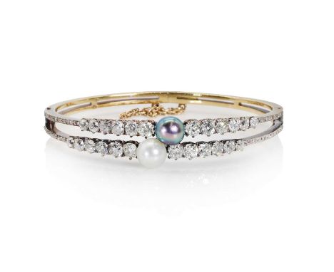 An 18ct gold diamond and pearl hinged bangle,  the top half with two rows of graduated old cut diamonds in coronet collets, e