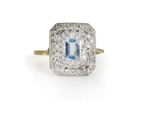 An aquamarine and diamond cluster ring,  of chamfered rectangular form, centrally set with a step cut aquamarine within a dou