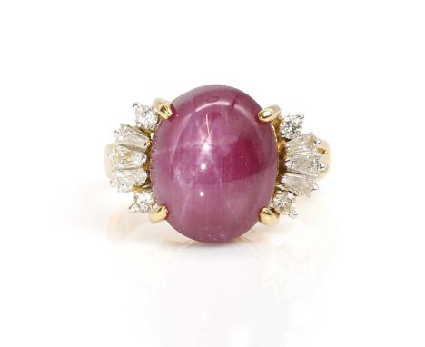 A star ruby and diamond ring,  the oval cabochon star ruby, with a weight estimated as in excess of 20.00ct, four claw set to