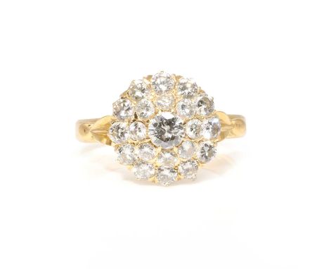 A diamond cluster ring,  with a larger round brilliant cut to the centre, estimated weight 0.20ct, surrounded by two further 