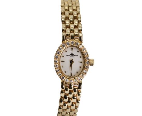 A ladies' 14ct gold Baume & Mercier quartz bracelet watch,  ref 7622, 15 x 18mm, with an oval case, a white enamel dial with 