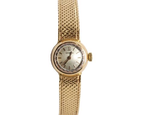 An 18ct gold Omega ladies' mechanical bracelet watch,  15mm case, with a silvered dial, gilt raised baton and gilt hands, dia