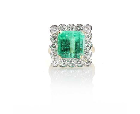 An 18ct gold Colombian emerald and diamond cluster ring,  claw set with a square step cut emerald, 12.10 x 11.90mm, estimated