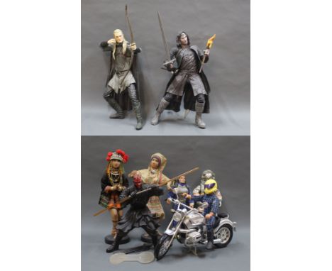 A group of NECA action figures, comprising Lord of the Rings Legolas and Aragorn, Action Man dolls, ethnic dolls, and others.