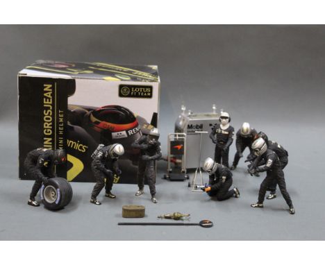 A Lotus F1 Team Romain Grosjean mini scale helmet and a plastic eight man pit stop crew with accessories