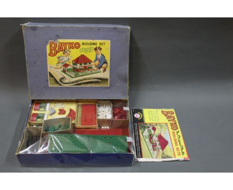 A Bayko building set with instructions.