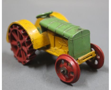 A pre-war Dinky 22E farm tractor, in green/yellow, with red wheels. 