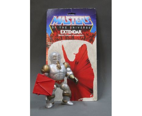A 1985 Mattel Masters of the Universe He-Man Extendar action figure with weapon and card.
