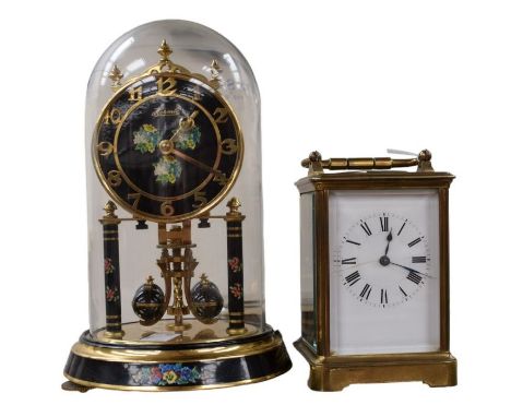 A striking carriage clock together with an Anniversary clock under glass dome.
