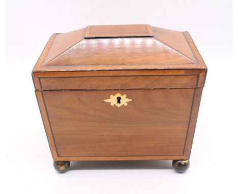 A mid-19th century mahogany two compartment tea caddy with Russian eagle detail handles on ball feet.