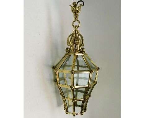 A late 19th/early 20th century brass and glass hanging stylised hall lantern. Approx. 88cm high x 30cm wide.