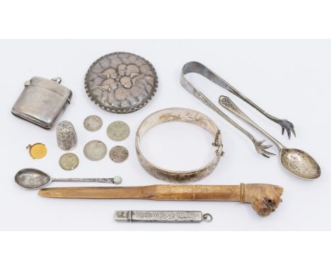 A collection of early 20th Century silver to include: a needle case, vesta case, bangle, thimble, bottle cover chased with Re