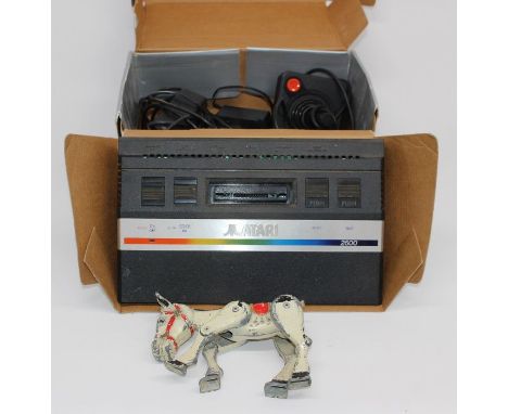A Muffin the Mule tin model and a small boxed Atari console.