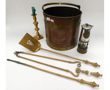 A collection of brass and copper wares, including coal bucket, fire irons, candlesticks, miner's lamp.