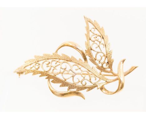 A 9ct gold brooch in the form of a leaf, open scroll work decoration, length approx 55mm, roller clasp and pin, weight approx