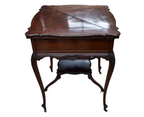 An Edwardian mahogany four section folding card/games table with single drawer and central shelf, supported on splayed legs a