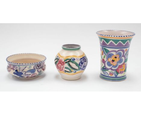 A group of Poole pottery to include: bluebird low jardiniere, baluster vase and a tapering vase both decorated with various f