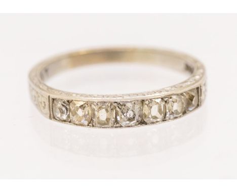 A vintage diamond and 18ct white gold half eternity ring, set with tapering old cut diamonds, width approx 3mm, engraved deco