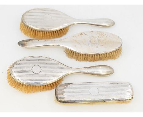 A collection of silver vanity brushes, one Birmingham silver oblong clothes brush with engine turned design, two similar desi