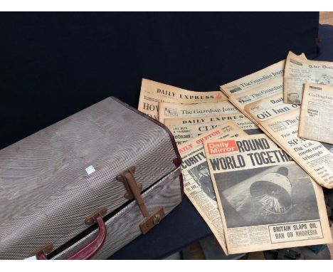 A 20th century handled suitcase trunk, lockable, with old newspapers inside.&nbsp;