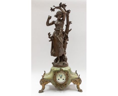 A large Victorian French mantel or novelty clock depicting a girl collecting apples under a tree. The bronze style casting is