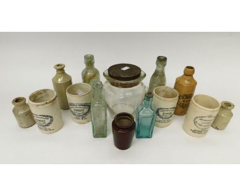 A collection of vintage early 20th century glass medicine bottles and stoneware bottles
