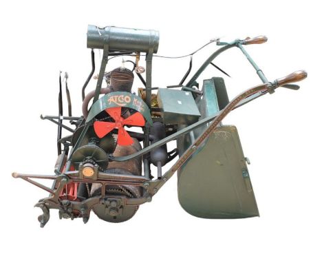 An Atco motor mower, petrol driven, the iron work marked Chas H Pugh Ltd of Birmingham, with roller and grass box.