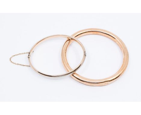 A 9ct gold hollow slave bangle, width approx 7mm, internal diameter approx 70mm, (dents throughout) weight approx 16.9gms alo