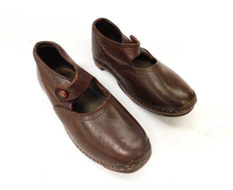 One pair of leather children's clogs, probably from the 1930s, with a bar and button fastening.