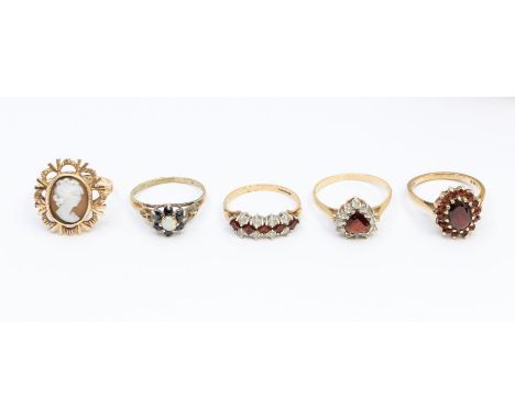 A collection of 9ct gold stone set rings to include a cameo, size M1/2, garnet cluster, size M, a garnet and white stone hear