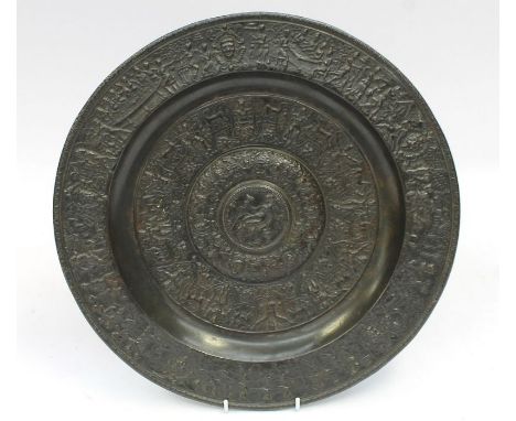 A 19th Century bronze charger depicting figures hunting and feasting, marked verso for John Crowley of Sheffield, diameter 37