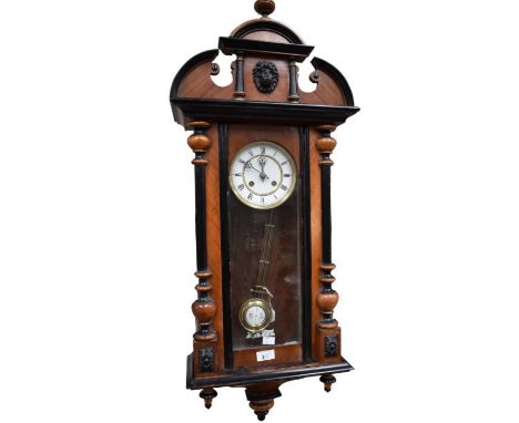 Vienna wall clock with 8 day spring driven 2 train movement striking on a gong. With 5" two piece pendulum dial Roman numeral