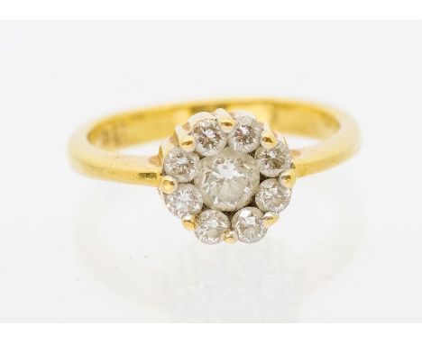 A diamond and 18ct gold cluster ring, comprising a central round brilliant cut diamond approx 0.40ct, assessed colour G/H ass