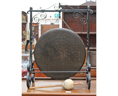 A mid 20th century bronze dinner gong on a cast-iron frame.