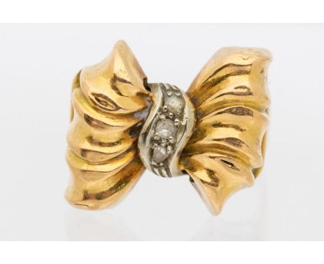 A diamond 18ct gold Retro bow ring, comprising a raised gold bow, with white gold centre set with stone set accents, width ap