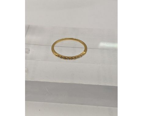 An 18ct gold ring with a band of diamondsLocation: 